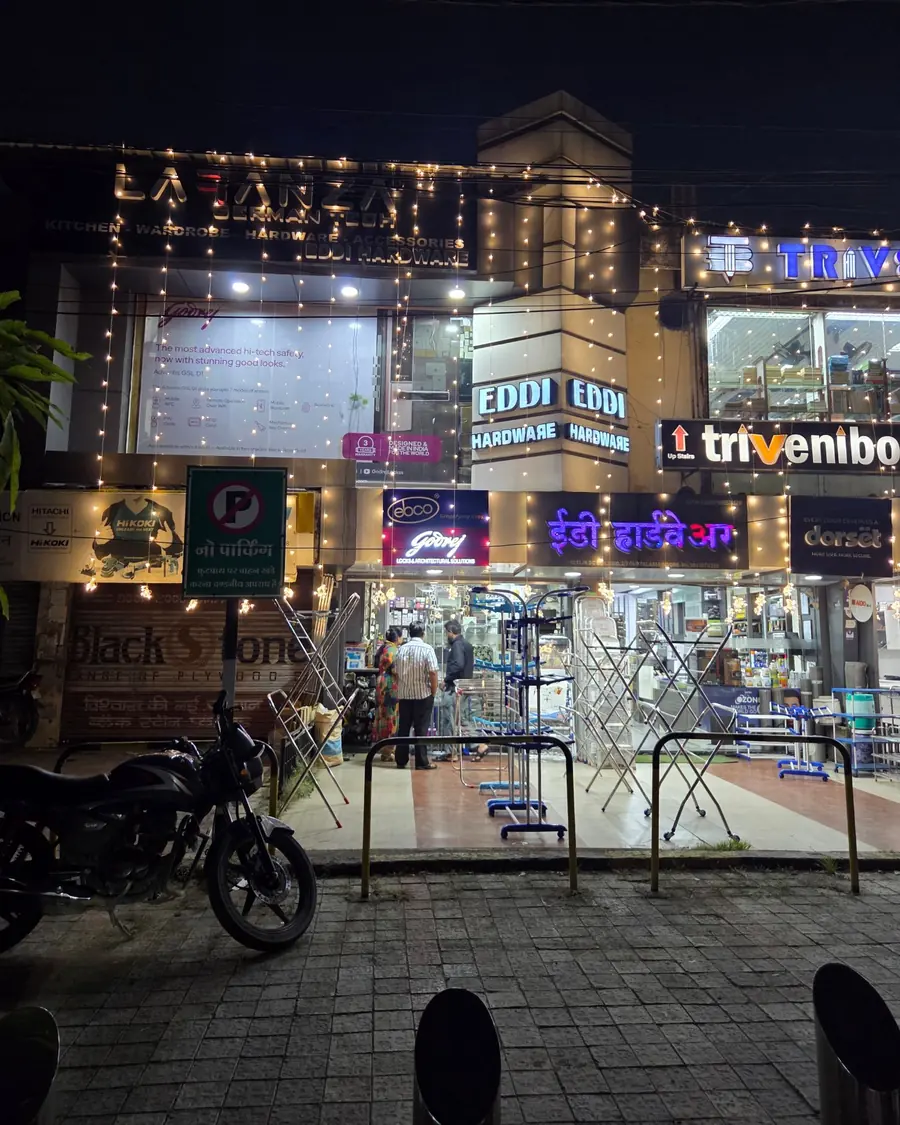 The Eddi Hardware frontage at night with illuminated signs